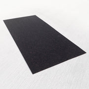 Shock-absorbent 3/8 inch rubber mat for a squat rack on top of a gray surface.