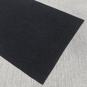 Commercial-grade recycled rubber fitness mat on a textured gray surface