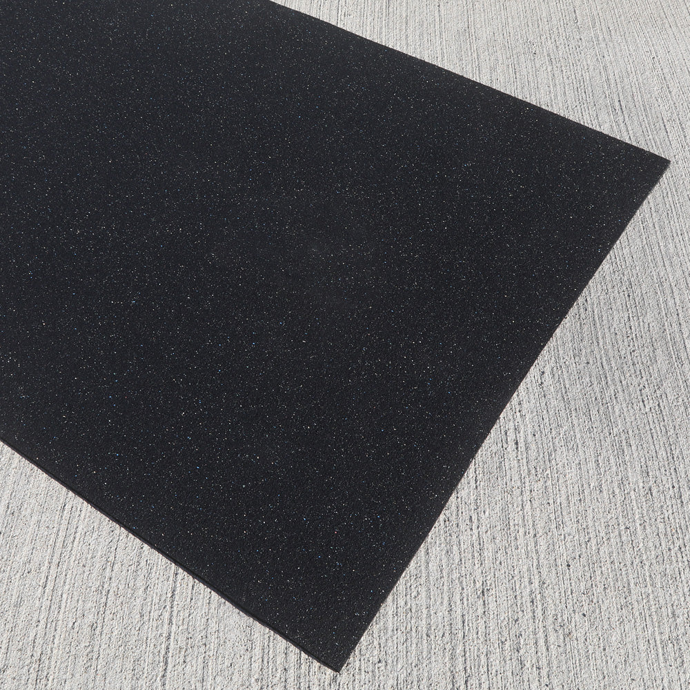 Commercial-grade recycled rubber fitness mat on a textured gray surface