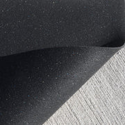 Close-up of a textured black surface with a white background