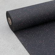 Terra Cotta fleck rubber gym roll laying on the concrete.