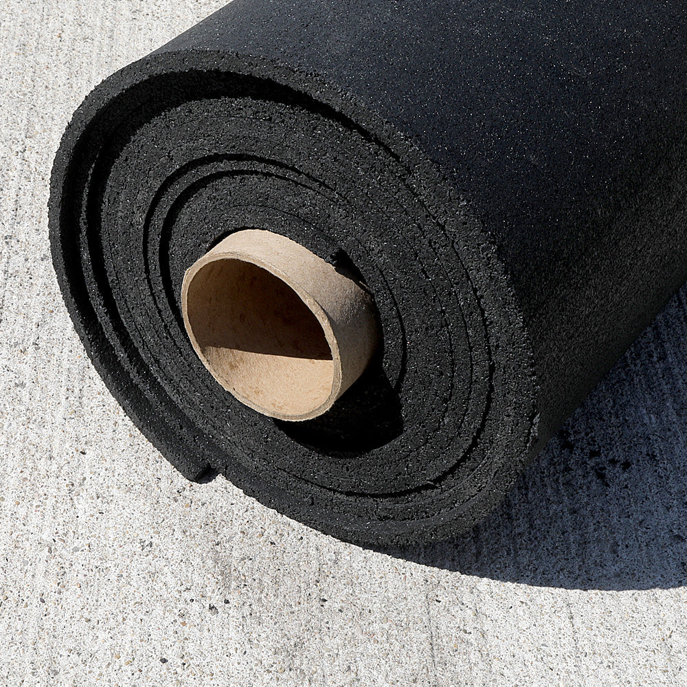 Black rubber gym roll laying on the concreate.