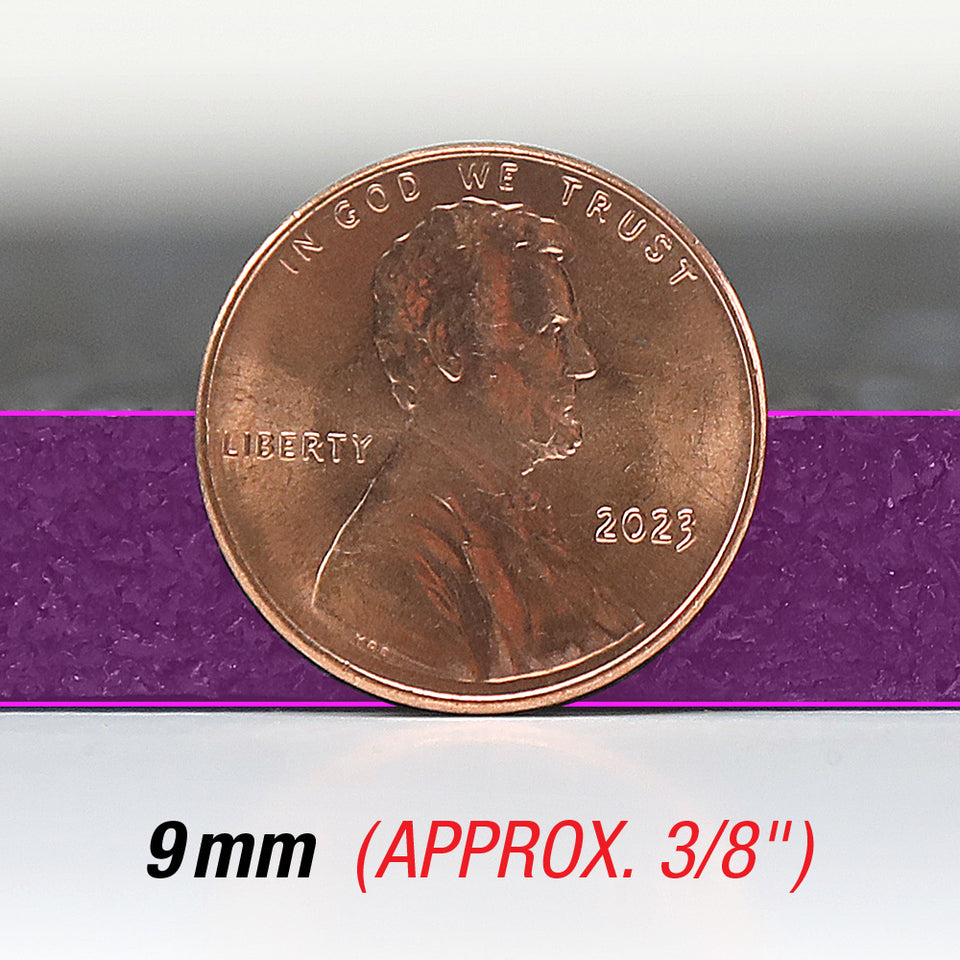 A penny on its side comparing it to the thickness of a 3/8" thick rubber floor.