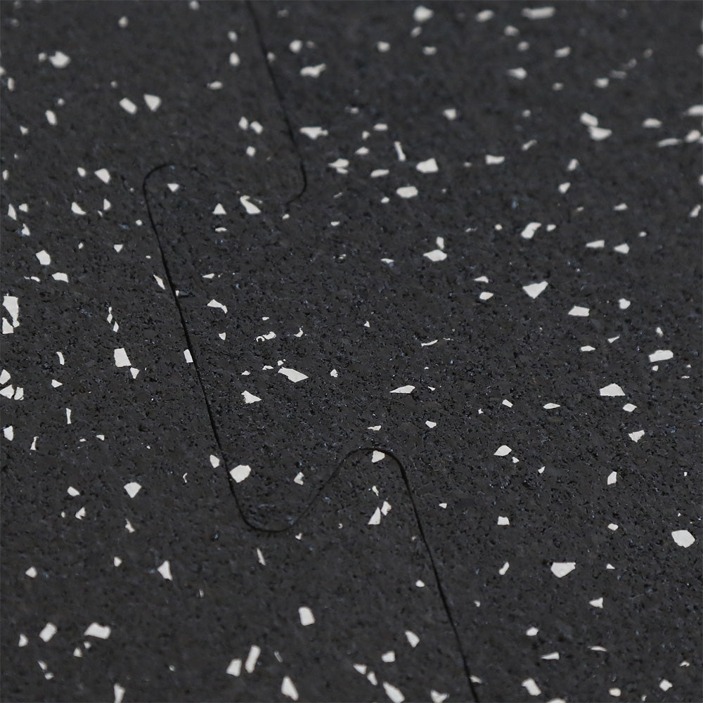 Close up of two rubber gym tiles interlocking together.