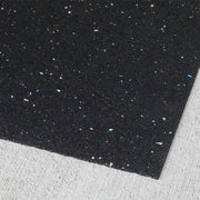 Close-up of 2mm rubber underlayment with specks on a gray surface
