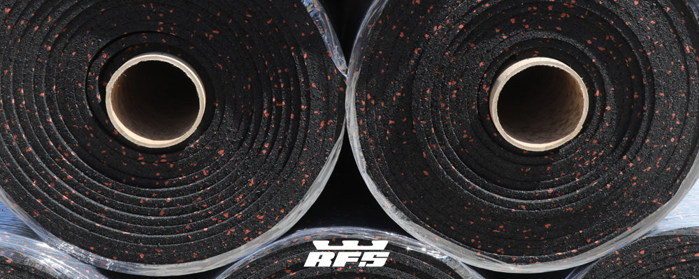 Five American-made recycled rubber flooring rolls stacked