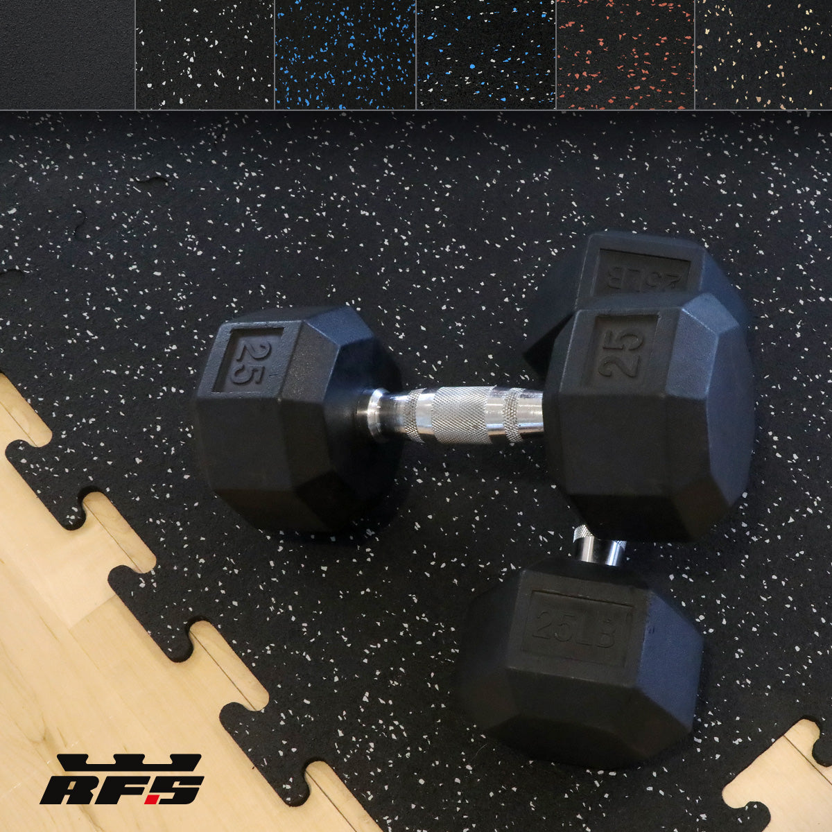 Hex dumb bells sitting on a 24 x 24 interlocking black rubber tile with gray specks