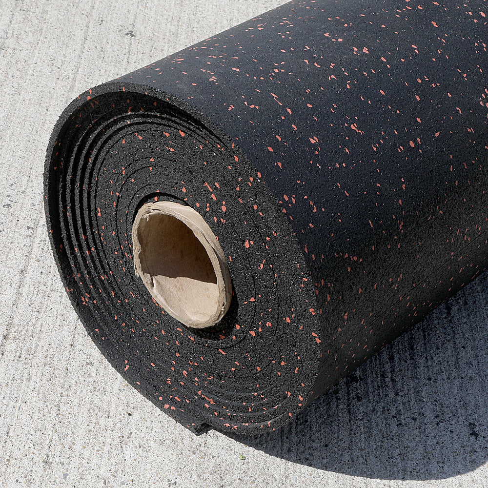 Roll of black rubber gym flooring with terra cotta specks on a concrete surface.