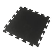 Black rubber gym tile over a white background. 