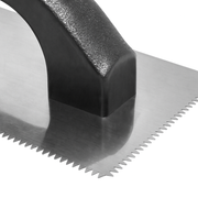 Close up view of trowel showing the detail of the v-notch.