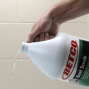 Person pouring liquid from a BETCO Best Scrub container into a container.