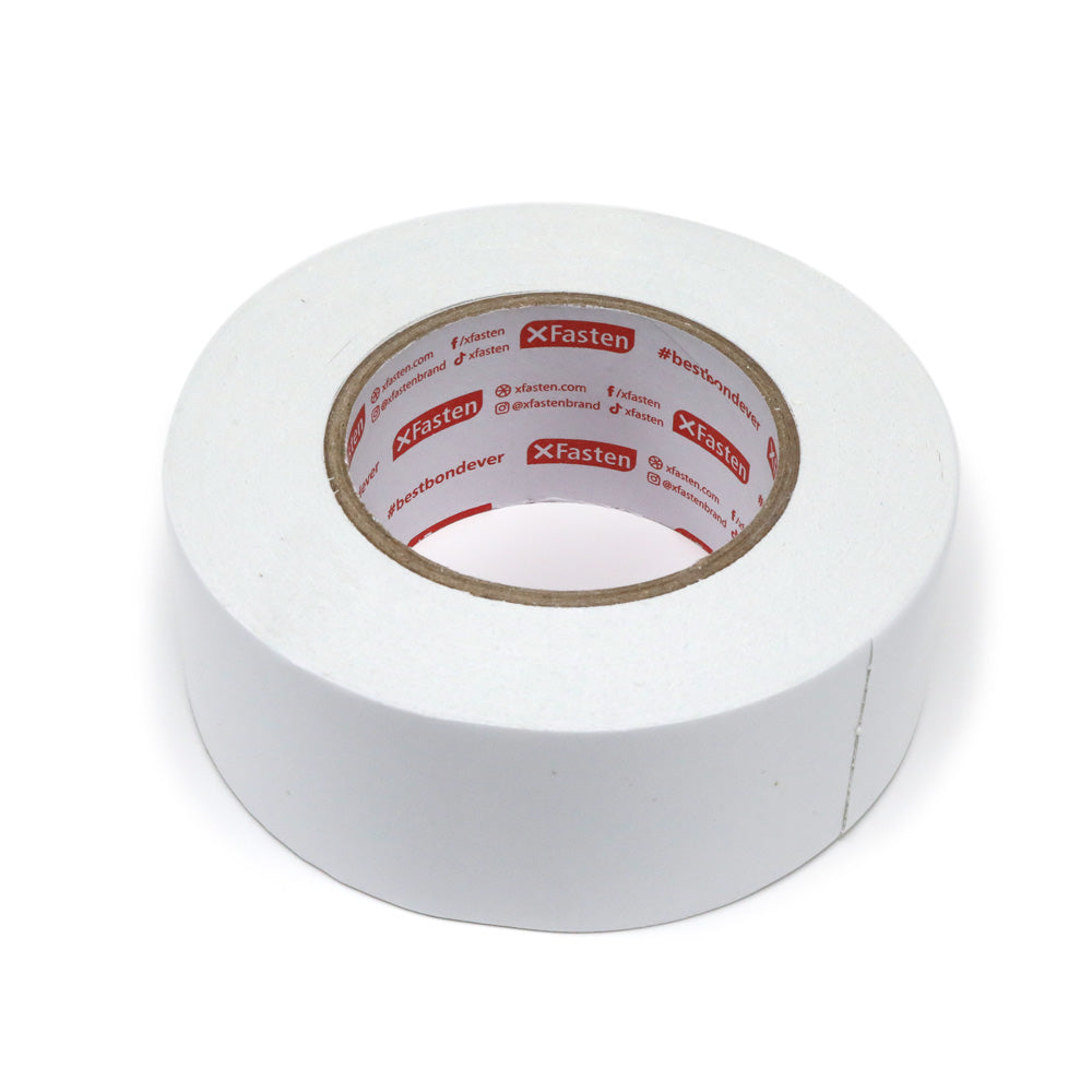 Roll of double sided tape laying on its side. 